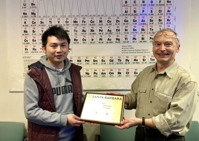 Xie receiving his plaque, with Chris