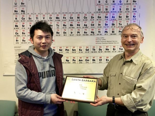 Xie receiving his plaque, with Chris